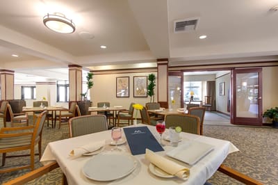 Dining area with table settings and drink options