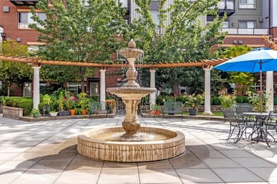 Fountain in a landscaped outdoor space with seating