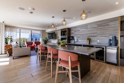 Bright and modern common area with seating and kitchenette