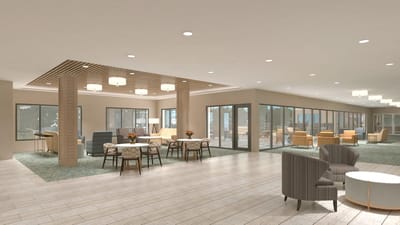 A bright common area with seating and tables