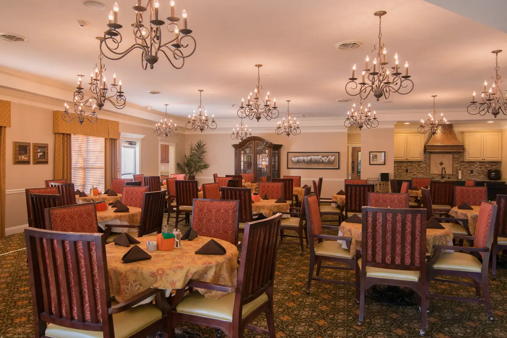 Dining area with elegant chandeliers and table settings