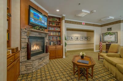Cozy common area with a fireplace and bookshelf