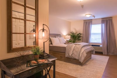 Cozy interior of a resident room with a bed and decor