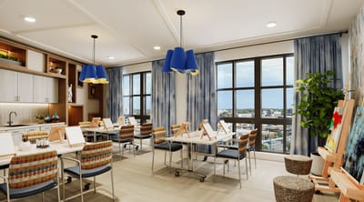 Bright interior activity room with art supplies and views