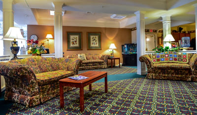 Common area with floral sofas and decorative lamps