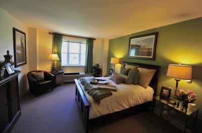 A cozy resident bedroom with natural light