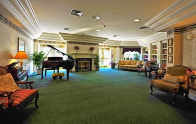 Common area with piano and seating in a cozy lounge