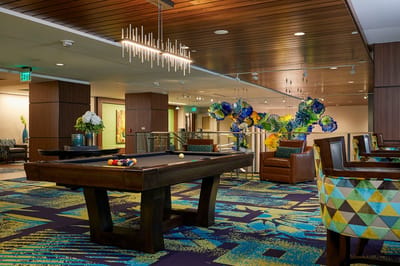 A bright common area with pool table and colorful decor