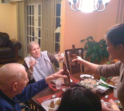 Residents celebrating at a dining table with food