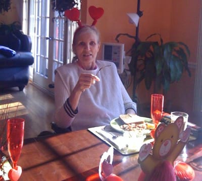 Resident enjoying a meal in a decorated dining area