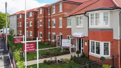 Exterior view of a senior living facility with landscaped entrance