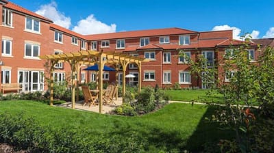 Outdoor patio area with seating and gardens