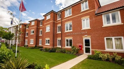 Exterior view of New Pooles Lodge building with landscaped area