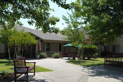 Outdoor courtyard with benches and greenery