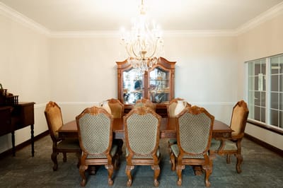 Elegant dining room with ornate furniture and chandelier