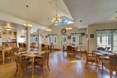 Bright dining area with wooden tables and chairs