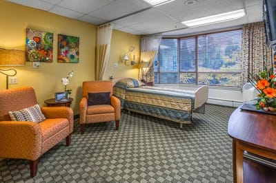 A comfortable resident room with seating and decor