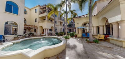 Outdoor courtyard with a fountain and palm trees