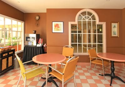 Bright common area with seating and coffee machine
