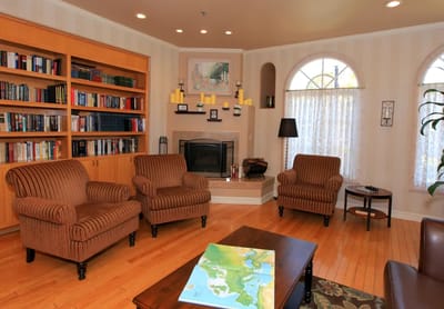 Cozy common area with seating and a bookshelf