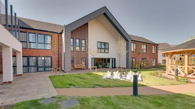 Exterior view of Parsons Grange Care Home with outdoor space