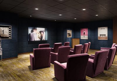 Cozy theater room with plush seating and movie screen
