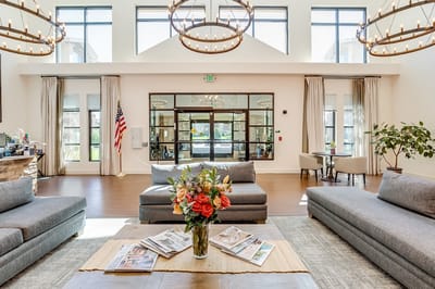 Bright lobby area with comfortable seating and floral arrangement