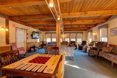 Cozy common area with comfortable seating and a game table