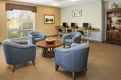 Common area with blue chairs and computers