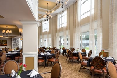 Elegant dining room setting with tables and chairs