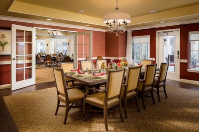 A beautifully set dining room table in a senior living facility