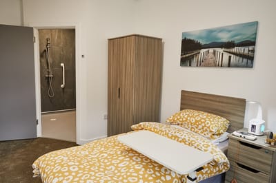 A private resident room with a bed and bathroom.