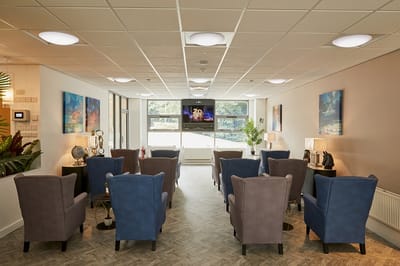 Bright common area with comfortable chairs and art