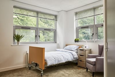 Cozy resident room with natural light and basic amenities
