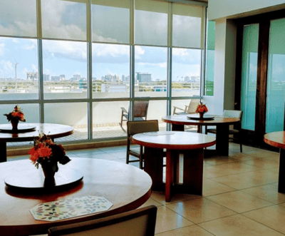 Bright dining area with tables and city view