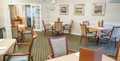 Dining area with tables and chairs in a well-lit room