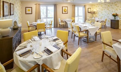 Bright dining room with tables set for meals