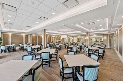 Dining area with tables and chairs set up for residents