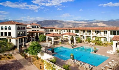 Outdoor pool area of a senior living facility with mountains