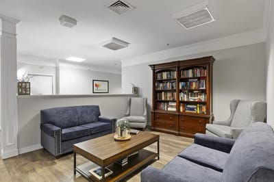 Cozy common area with seating and a bookshelf