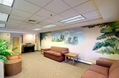 Common area with seating and mural decorations