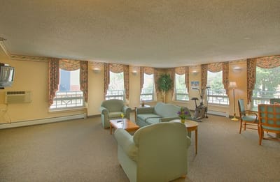 Bright common area with seating and exercise equipment