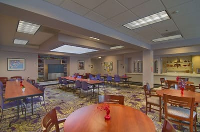 Bright common area with tables set for activities