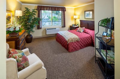 Cozy resident room with a bed and seating area