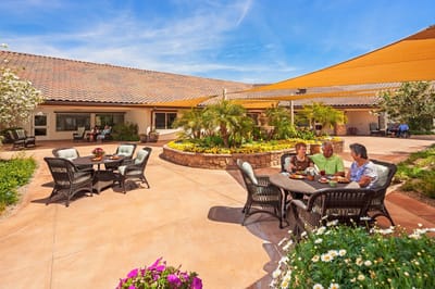 Residents enjoying the outdoor patio with a garden