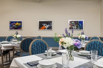 Dining room set up for a meal with floral centerpieces