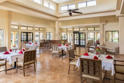 Bright dining room with tables set for meals