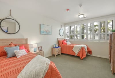 Brightly decorated resident bedroom with two beds