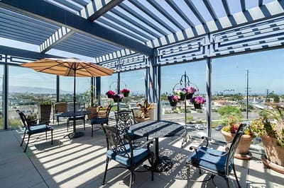 Outdoor patio with tables and hanging plants