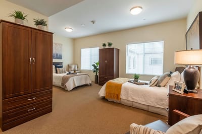 Cozy shared resident room with twin beds and decor